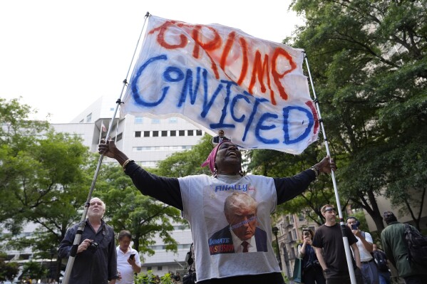 A demonstrator reacts to the guilty verdict announced against former President Donald Trump outside Manhattan Criminal Court, Thursday, May 30, 2024, in New York. Donald Trump became the first former president to be convicted of felony crimes as a New York jury found him guilty of 34 felony counts of falsifying business records in a scheme to illegally influence the 2016 election through hush money payments to a porn actor who said the two had sex. (AP Photo/Julia Nikhinson)