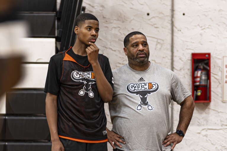 Book Richardson, director of the New York Gauchos boy's basketball program, speaks with a player during a practice session at the Gaucho Gym, Monday, March 11, 2024, in the Bronx borough of New York. Richardson is one of four assistant coaches — along with a group of six agents, their financial backers and shoe company representatives — who were arrested in the 2017 federal probe aimed at rooting out an entrenched system of off-the-books payments to players and their families that, at the time, was against NCAA rules. (AP Photo/Peter K. Afriyie)