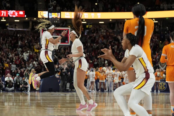 South Carolina center Kamilla Cardoso, middle, celebrates after scoring the game winning basket with guard Te-Hina Paopao, left, against Tennessee during the second half of an NCAA college basketball game at the Southeastern Conference women's tournament Saturday, March 9, 2024, in Greenville, S.C. (AP Photo/Chris Carlson)
