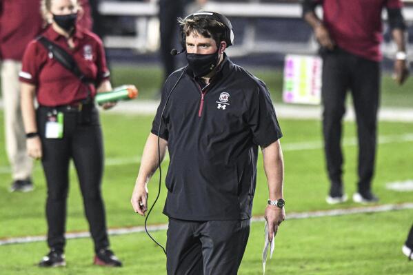 South Carolina coach Will Muschamp heads to check on an injured player during the first half of the team's NCAA college football game against Mississippi in Oxford, Miss., Saturday, Nov. 14, 2020. (AP Photo/Bruce Newman)