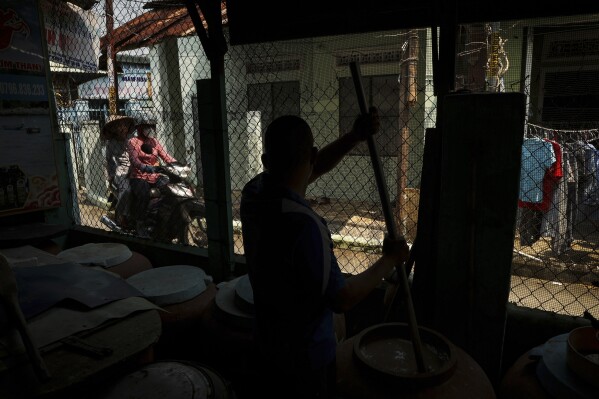 Phan Cong Quang makes fish sauce in his home in Nam O fishing village on March 4, 2025, in Da Nang, Vietnam. (AP Photo/Yannick Peterhans)
