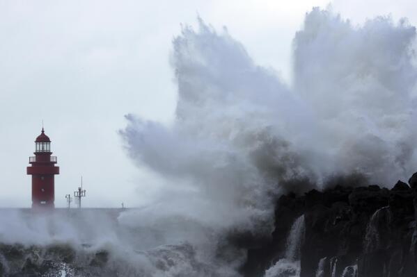 Waves crash on the eastern coast of Jeju Island, South Korea, as Typhoon Hinnamnor travels toward the Korean Peninsula on Sunday, Sept. 4, 2022. Cities in eastern China suspended ferry services and classes and flights were canceled in Japan on Sunday as Typhoon Hinnamnor, the strongest global storm this year, blew its way past Taiwan and the Koreas with fierce winds and heavy rains. (Han Sang-kyun/Yonhap via AP)