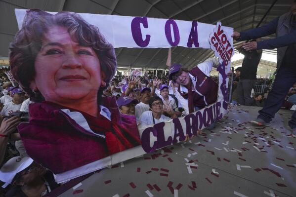 MORENA political party gubernatorial candidate Delfina Gomez, right, poses with a cardboard cutout with her image during a campaign rally in Valle de Chalco, Mexico, Sunday, May 28, 2023. Voters in the state of Mexico go to the polls on June 4 to elect a new governor. (AP Photo/Marco Ugarte)