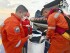 In this photo provided by the Philippine Coast Guard, Philippine Coast Guard personnel collect oil that are part of the slick from fuel that powered the tank to prevent it from spreading near east of Lamao Point, Limay, Bataan, Philippines Friday, July 26, 2024. (Philippine Coast Guard via ĢӰԺ)
