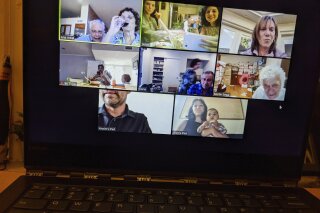 In this April 8, 2020, photo, Tali Arbel and her family and friends from other places are pictured on a New York computer screen during a virtual Seder for Passover. (AP Photo/Tali Arbel)