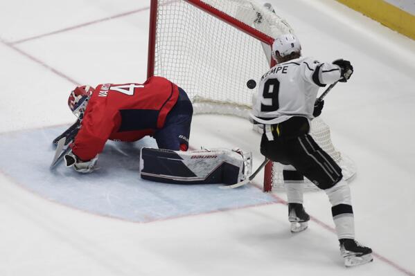 Los Angeles Kings' Adrian Kempe (9) scores the winning goal against Washington Capitals goalie Vitek Vanecek, left, during the third period of an NHL hockey game, Sunday, Dec. 19, 2021, in Washington. (AP Photo/Luis M. Alvarez)