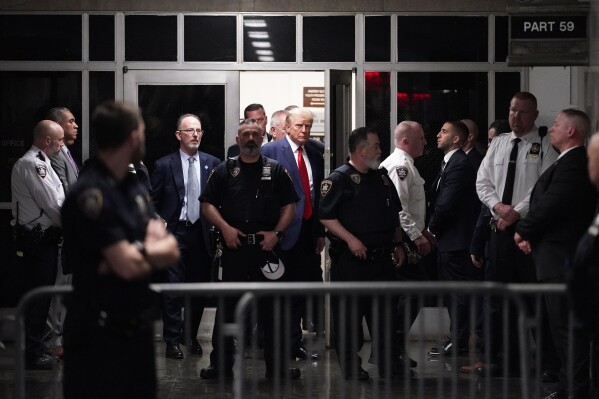 FILE - Former President Donald Trump is escorted to a courtroom, April 4, 2023, in New York. A federal judge has rejected Donald Trump's bid to move his hush-money criminal case from New York state court to federal court. He ruled that the former president had failed to meet a high legal bar for changing jurisdiction. (AP Photo/Mary Altaffer, File)