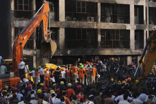 Search and rescue teams respond to the scene of a plane crash in Ahmedabad, India, Thursday, June 12, 2025. (AP Photo/Ajit Solanki)