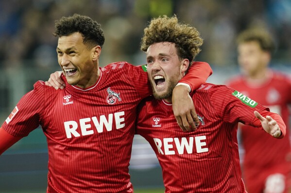 Cologne's Davie Selke, left, and Cologne goalscorer Luca Waldschmidt celebrate the 0:2 goal during the Bundesliga soccer match between Cologne and Darmstadt in Darmstadt, Germany, Friday Dec. 1, 2023. (Uwe Anspach/dpa via AP)