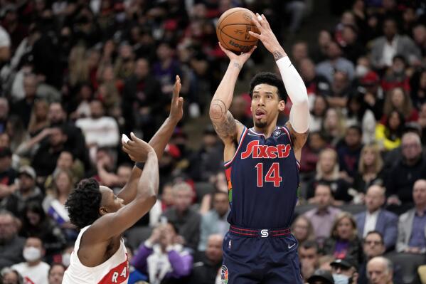 FILE - Philadelphia 76ers forward Danny Green (14) shoots over Toronto Raptors forward OG Anunoby (3) during the second half of Game 6 of an NBA basketball first-round playoff series in Toronto, on April 28, 2022. Green officially re-joined Cleveland's roster on Tuesday, Feb. 14, 2023, after agreeing to a one-year, $2 million contract with the Cavs, who believe the three-time NBA champion can help them in the postseason. Green, who was drafted by Cleveland in 2009 and waived after one season, gives the Cavs another proven outside shooter. (Frank Gunn/The Canadian Press via AP, File)