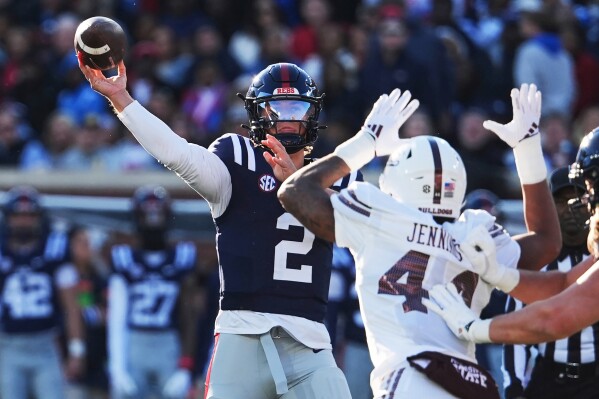 Mississippi quarterback Jaxson Dart (2) passes while being pressured by Mississippi State linebacker Branden Jennings (44) during the first half of an NCAA college football game, Friday, Nov. 29, 2024, in Oxford, Miss. (AP Photo/Rogelio V. Solis, File)