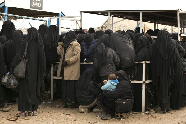 FILE - Women residents from former Islamic State-held areas in Syria line up for aid supplies at Al-Hol camp in Hassakeh province, Syria, March 31, 2019. Amnesty International said Wednesday, April 17, 2024 it has documented widespread abuses, including torture and deprivation of medical care, in detention facilities holding thousands of suspected Islamic State members and their relatives in northeast Syria. (AP Photo/Maya Alleruzzo, File)