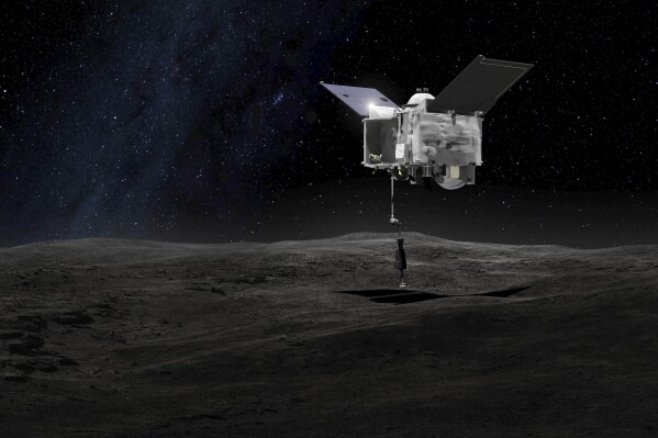 Esta representación artística proporcionada por la NASA el 6 de septiembre de 2016 muestra la nave espacial OSIRIS-REx tomando muestras del asteroide Bennu. (NASA/Centro de vuelos espaciales Goddard vía AP, Archivo)