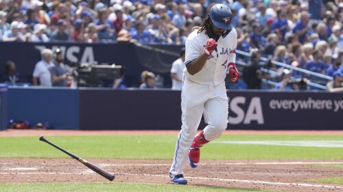 Toronto Blue Jays' Vladimir Guerrero Jr. celebrates after hitting a sacrifice fly off Arizona Diamondbacks relief pitcher Kevin Ginkel to bring in Blue Jays' Kevin Kiermaier during the fifth inning of baseball game action in Toronto, Sunday, July 16, 2023. (Chris Young/The Canadian Press via AP)