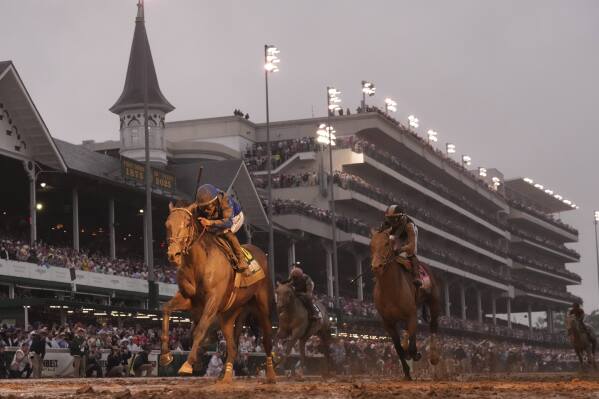Sovereignty, ridden by Junior Alvarado, left, crosses the finish line to win the 151st running of the Kentucky Derby horse race at Churchill Downs Saturday, May 3, 2025, in Louisville, Ky. (AP Photo/Abbie Parr)