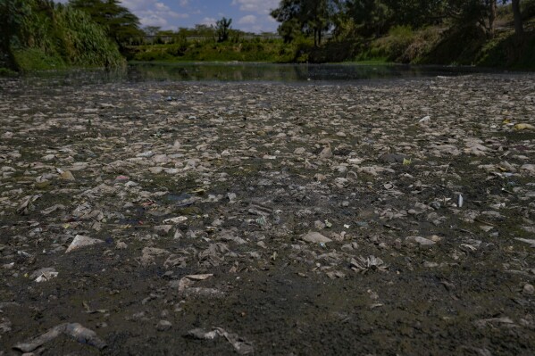 Pollution is visible at the Athi River in Machakos county, Kenya, Tuesday, Oct. 17, 2023. There is no piped water or sewage system in Athi River, near Kenya's capital Nairobi, and drought is making clean water supplies more scarce and expensive for locals. (AP Photo/Brian Inganga)
