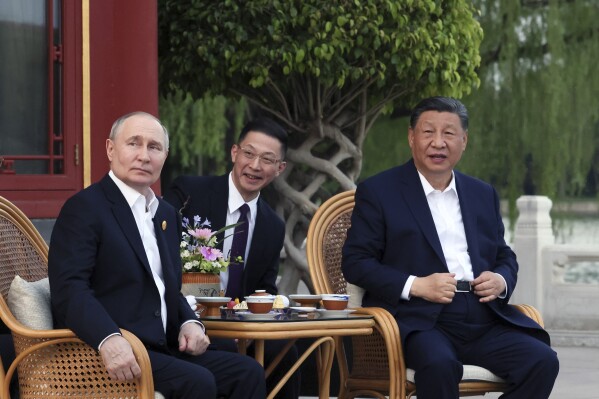 Russian President Vladimir Putin, left, and Chinese President Xi Jinping, right, attend an informal meeting in Beijing, China, on Thursday, May 16, 2024. (Mikhail Metzel, Sputnik, Kremlin Pool Photo via AP)