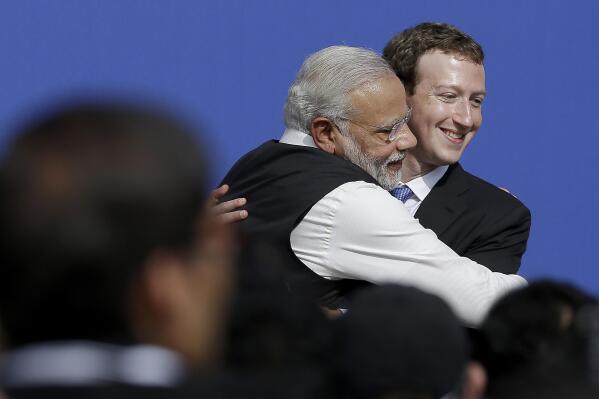 FILE - In this  Sept. 27, 2015, file photo, Facebook CEO Mark Zuckerberg, right, hugs Prime Minister of India Narendra Modi at Facebook in Menlo Park, Calif.. Facebook in India has been selective in curbing hate speech, misinformation and inflammatory posts, particularly anti-Muslim content, according to leaked documents obtained by The Associated Press, even as the internet giant's own employees cast doubt over the motivations and interests. (AP Photo/Jeff Chiu, File)