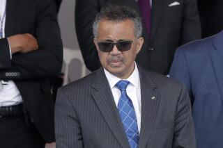 FILE - In this file photo dated Tuesday, July 14, 2020, Director General of the World Health Organization, Tedros Adhanom Ghebreyesus, attends the Bastille Day military parade, in Paris.  The head of the World Health Organization has appealed Wednesday Aug. 4, 2021, for a moratorium on administering booster shots of COVID-19 vaccines, to ensure doses are available in countries where few people have yet received their first shots. (AP Photo/Christophe Ena, FILE)