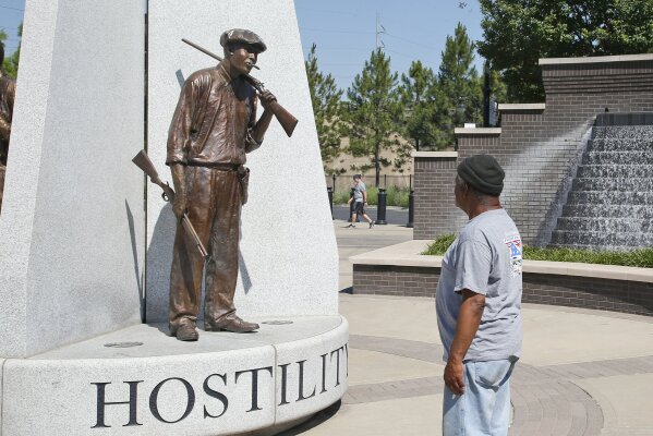 Donald Shaw looks at a sculpture in the John Hope Franklin reconciliation park in Tulsa, Okla., Monday, June 15, 2020, a few hundred yards and on the other side of what's historically the city's white-black dividing line, where President Donald Trump will rally Saturday, June 20. (AP Photo/Sue Ogrocki)