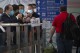 FILE - People wearing face masks wait at the international passenger arrivals area at Beijing Capital Inernational Airport in Beijing, on March 15, 2023. China announced Friday, Nov. 24, 2023 that it will allow visa-free entry for citizens of five European countries and Malaysia as it tries to encourage more people to visit for business and tourism. (AP Photo/Mark Schiefelbein, File)