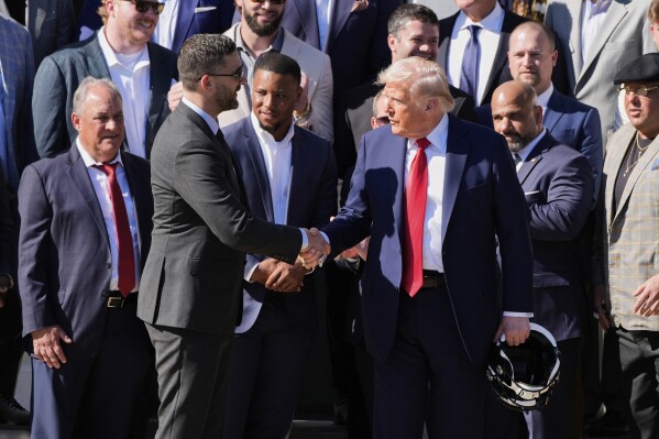 President Donald Trump, right, shakes the hand of Philadelphia Eagles coach Nick Sirianni, as Trump welcomes the Super Bowl champion NFL football team to the South Lawn of the White House, Monday, April 28, 2025, in Washington. (AP Photo/Alex Brandon)