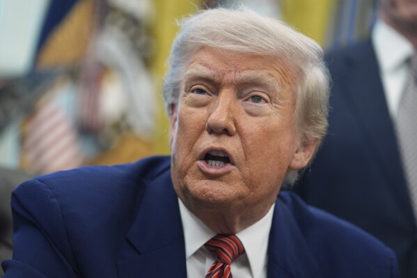 President Donald Trump speaks to reporters in the Oval Office of the White House, Friday, May 23, 2025, in Washington. (AP Photo/Evan Vucci, File)