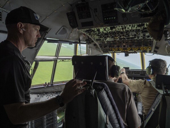 Fogbow COO Eric Oehlerich stands in the cockpit of his plane during an airdrop of food in Nasir, Upper Nile, South Sudan, Monday, June 9, 2025. (AP Photo/ Florence Miettaux)