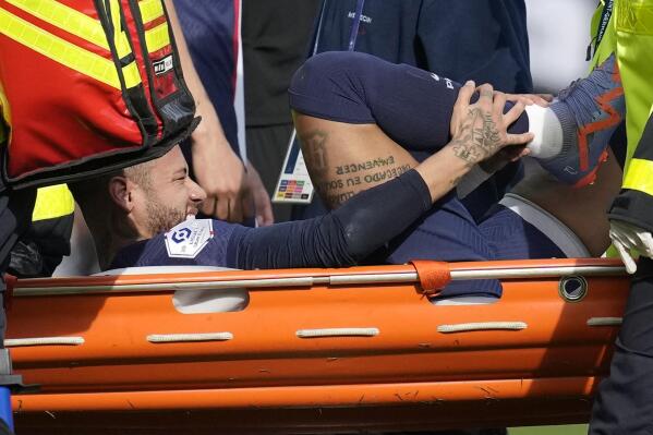 PSG's Neymar is carried off the field on a stretcher after after injuring during the French League One soccer match between Paris Saint-Germain and Lille at the Parc des Princes stadium, in Paris, France, Sunday, Feb. 19, 2023. (AP Photo/Christophe Ena)