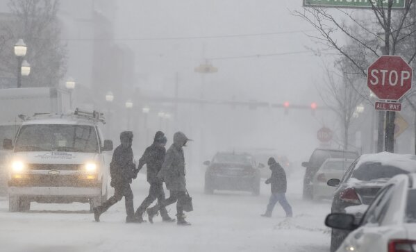 
              People walk through a snowstorm in downtown Jackson, Mich., Monday, Jan. 28, 2019. (J. Scott Park/Jackson Citizen Patriot via AP)
            