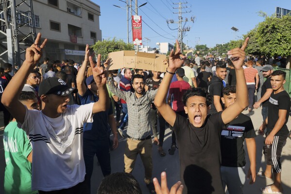 Palestinian demonstrators chant slogans during a protest against the territory's chronic power outages and difficult living conditions along the streets of Khan Younis, southern Gaza Strip, Sunday, July 30, 2023. Several thousand people briefly took to the streets across the Gaza Strip chanting 