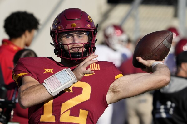 FILE - Iowa State quarterback Hunter Dekkers (12) warms up before an NCAA college football game against Oklahoma, Saturday, Oct. 29, 2022, in Ames, Iowa. Dekkers has been accused of gambling on Cyclone sports events, including a football game, and was charged Tuesday, Aug. 1, 2023, with tampering with records related to an Iowa Criminal Division investigation into sports gambling. (AP Photo/Charlie Neibergall, File)