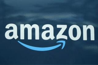 FILE - An Amazon logo appears on an Amazon delivery van, on Oct. 1, 2020, in Boston. Amazon announced Thursday, March 17, 2022 it has closed its acquisition of Hollywood studio MGM two days after European regulators said the deal “would not significantly reduce competition” in European markets. MGM is one of the oldest studios in Hollywood. (AP Photo/Steven Senne, File)