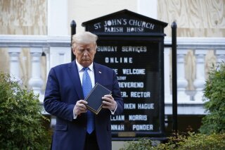 FILE - In this Monday, June 1, 2020 file photo, President Donald Trump holds a Bible during a visit outside St. John's Church across Lafayette Park from the White House in Washington. Polling released by the nonpartisan Pew Research Center on Wednesday, July 1, 2020 finds that Trump's strong approval among white evangelicals -- a cornerstone of his political base -- remains intact in the wake of the previous month's photo op at the church, which sparked criticism from some religious leaders, and the Supreme Court's ruling to protect LGBT people from employment discrimination. (AP Photo/Patrick Semansky)