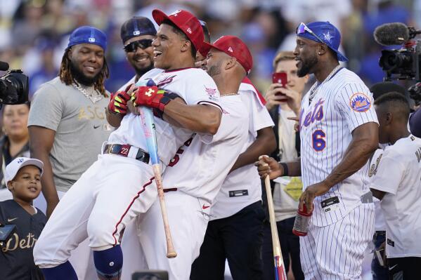 National League's Juan Soto, of the Washington Nationals, is lifted by National League's Albert Pujols, of the St. Louis Cardinals, during the MLB All-Star baseball Home Run Derby, Monday, July 18, 2022, in Los Angeles. (AP Photo/Abbie Parr)