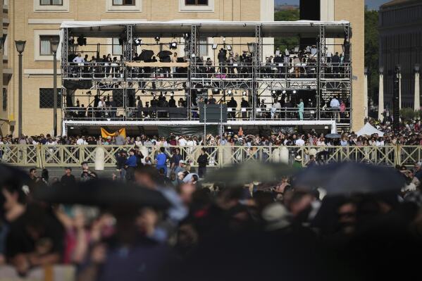 Television crews working at St. Peter's square wait to see smoke pour from the chimney of the Sistine Chapel where 133 cardinals are gathering on the second day of the conclave to elect a successor to late Pope Francis, at the Vatican, Thursday, May 8, 2025 (AP Photo/Alessandra Tarantino)