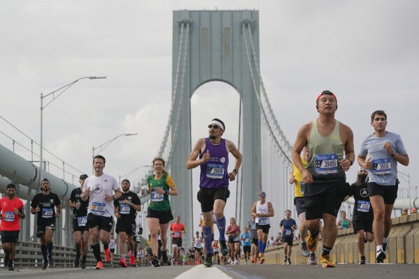 FILE - Runners cross the Verrazzano-Narrows Bridge at the start of the New York City Marathon in New York, Sunday, Nov. 6, 2022. The New York City Marathon organizers will soon have to pay a toll to cross a state bridge, just like every other commuter, if transit officials in New York have their way. The Metropolitan Transportation Authority is demanding the New York Road Runners, organizers of the venerable race held the first Sunday each November, to pay roughly $750,000 for use of the Verrazzano-Narrows Bridge. (AP Photo/Seth Wenig, File)