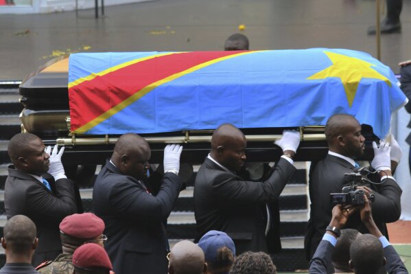 The coffin carrying the remains of longtime Congolese opposition leader Etienne Tshisekedi is carried at Kinshasa's Martyrs Stadium for his funeral ceremony Saturday June 1, 2019. Tshisekedi, father of the current Congolese president Felix Tshisekedi, died in Brussels in February 2017. (AP Photo/John Bompengo)
