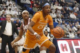 Tennessee's Jordan Horston (25) drives past Connecticut's Christyn Williams in the first half of an NCAA college basketball game, Sunday, Feb. 6, 2022, in Hartford, Conn. (AP Photo/Jessica Hill)