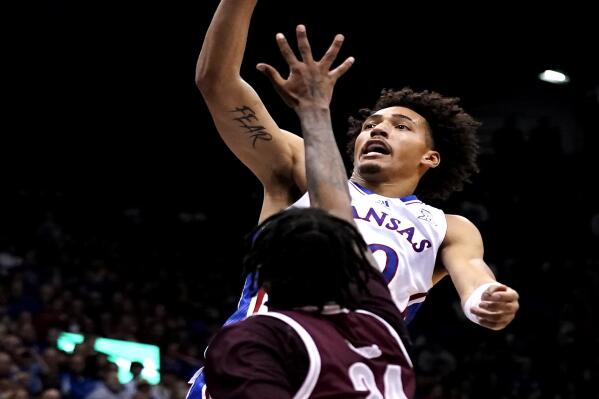 Kansas forward Jalen Wilson (10) shoots over Texas Southern forward John Walker III (24) during the first half of an NCAA college basketball game Monday, Nov. 28, 2022, in Lawrence, Kan. (AP Photo/Charlie Riedel)