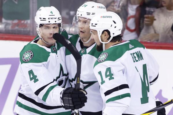 Dallas Stars' Denis Gurianov, center, celebrates his goal against the Calgary Flames with Miro Heiskanen, left, and Jamie Benn during the first period of an NHL hockey game Thursday, Nov. 4, 2021, in Calgary, Alberta. (Larry MacDougal/The Canadian Press via AP)