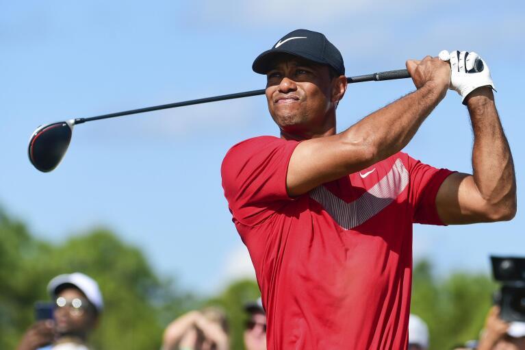 FILE - Tiger Woods follows his ball at the fourth tee during the last round of the Hero World Challenge at Albany Golf Club in Nassau, Bahamas, Saturday, Dec. 7, 2019. (AP Photo/Dante Carrer, File)