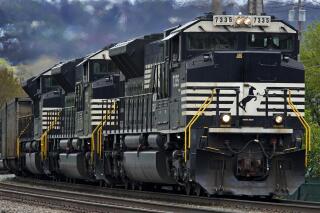 FILE - A Norfolk Southern freight train makes it way through Homestead, Pa. on April 27, 2022. Norfolk Southern reports earnings on Wednesday, April 26, 2023. (AP Photo/Gene J. Puskar, File)