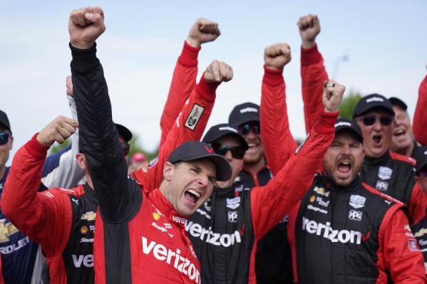 Will Power, left, celebrates with his team after winning the IndyCar Detroit Grand Prix auto race on Belle Isle in Detroit, Sunday, June 5, 2022. (AP Photo/Paul Sancya)