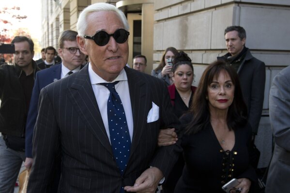 FILE - In this Nov. 15, 2019, file photo, Roger Stone, left, with his wife Nydia Stone, leaves federal court in Washington, Friday, Nov. 15, 2019. Federal prosecutors are asking a judge to sentence Stone to serve between 7 and 9 years in prison after his conviction on witness tampering and obstruction charges. (AP Photo/Jose Luis Magana, File)