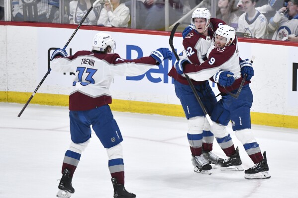 Colorado Avalanche Zach Parise (9) celebrates his goal against the Winnipeg Jets with Josh Manson (42) and Yakov Trenin (73) during the second period in Game 2 of an NHL hockey Stanley Cup first-round playoff series Tuesday, April 23, 2024, in Winnipeg, Manitoba. (Fred Greenslade/The Canadian Press via AP)