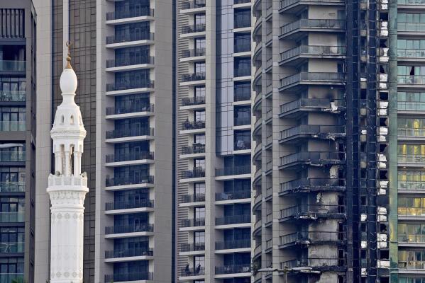 A part of the high-rise 8 Boulevard Walk shows fire damage in Dubai, United Arab Emirates, Monday, Nov. 7, 2022. A fire broke out early Monday morning at the 35-story high-rise building in Dubai near the Burj Khalifa, the world's tallest building. (AP Photo/Kamran Jebreili)