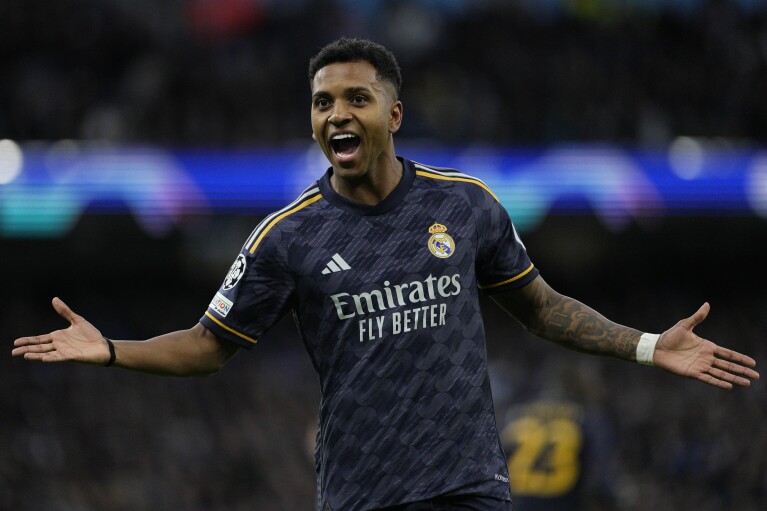 Real Madrid's Rodrygo celebrates after scoring his side's opening goal during the Champions League quarterfinal second leg soccer match between Manchester City and Real Madrid at the Etihad Stadium in Manchester, England, Wednesday, April 17, 2024. (AP Photo/Dave Shopland)