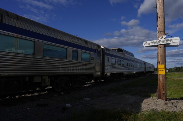 A train waits at a stop Friday, Aug. 9, 2024, in Wabowden, Manitoba. (AP Photo/Joshua A. Bickel)