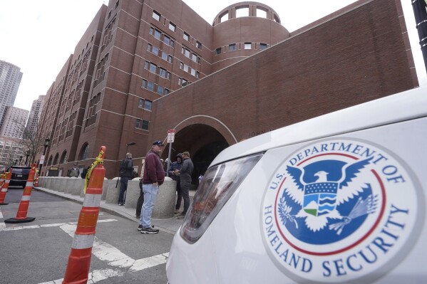 A Homeland Security vehicle, right, is parked outside the Moakley Federal Courthouse, April 19, 2023, in Boston. . (AP Photo/Steven Senne, File)